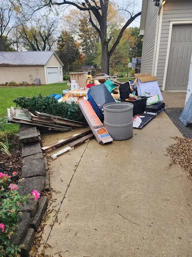 Dumpster being loaded with debris for 12 Yard Dumpster Rental in Montgomery